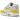 Nike Air Max 1 Tour Yellow sneakers i vinklet visning med hvid mesh overdel, gule ruskindsdetaljer og synlig Air enhed i sålen.
